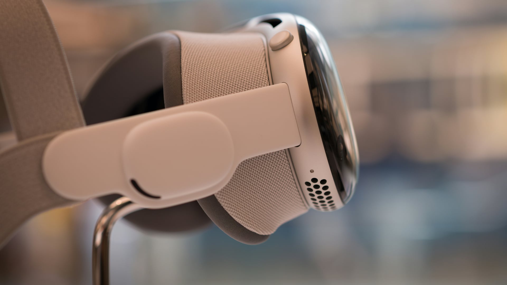 Apple Vision Pro headsets on a store display, shot from a side.