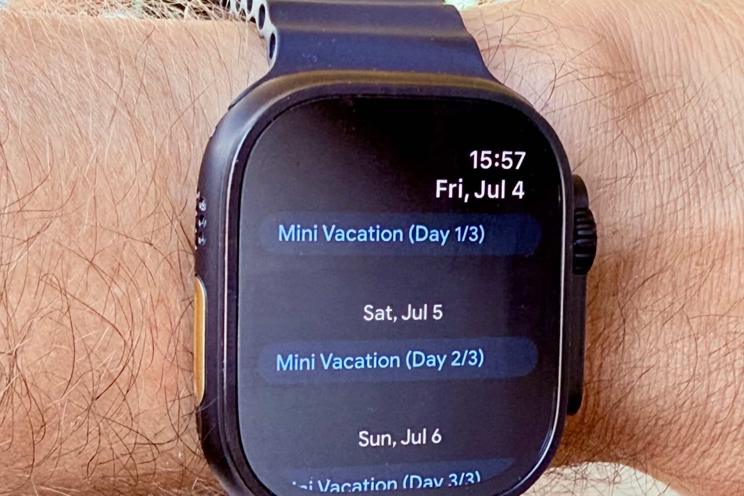 Apple Watch on a male wrist, running the Google Calendar app.